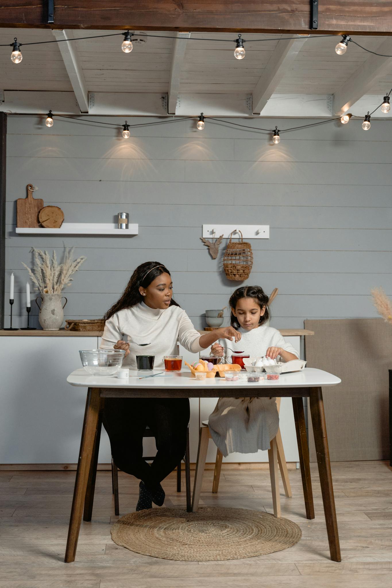 A mother and daughter enjoying quality time baking together in a stylish kitchen setting.