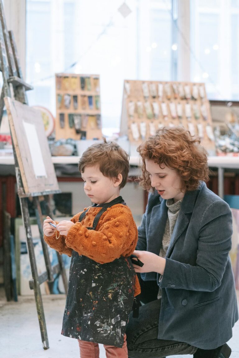 A mother assisting her child in an art studio, fostering creativity and bonding.
