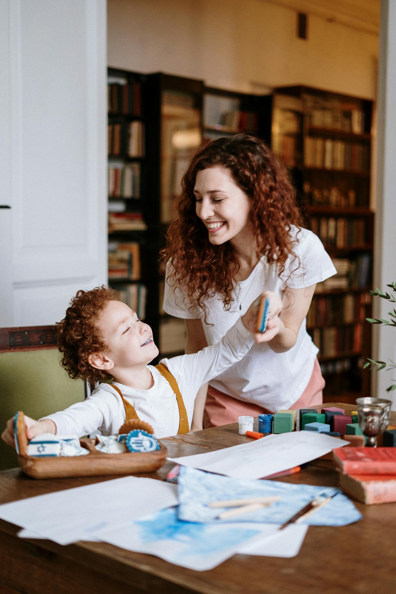 Mother and son enjoying creative playtime in a cozy home setting.